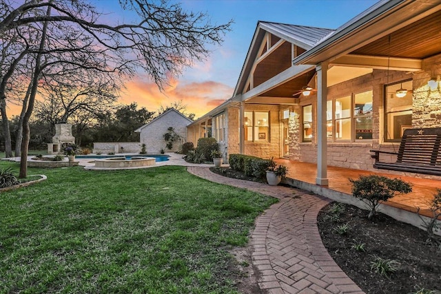 view of yard with a patio area, an outdoor pool, and ceiling fan