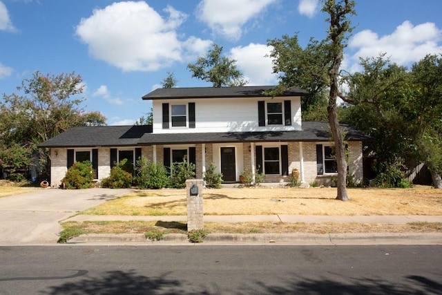 traditional-style home with brick siding and a porch