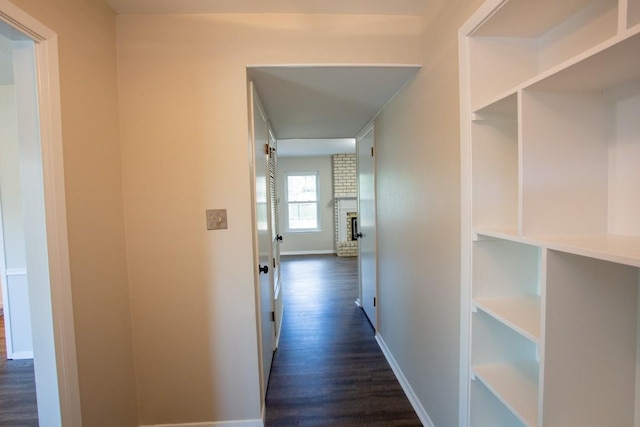 hall with dark wood finished floors and baseboards