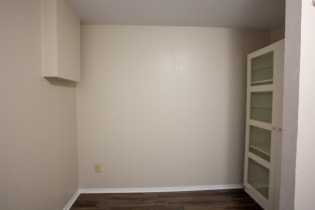 unfurnished room featuring dark wood finished floors and baseboards