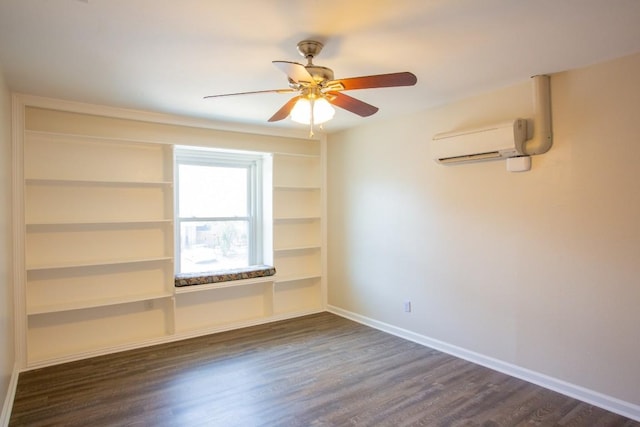 spare room with a wall unit AC, dark wood-style floors, baseboards, and ceiling fan