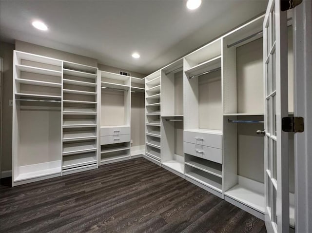 spacious closet with visible vents and dark wood-type flooring