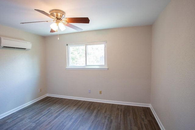 spare room with dark wood finished floors, a wall mounted air conditioner, and baseboards