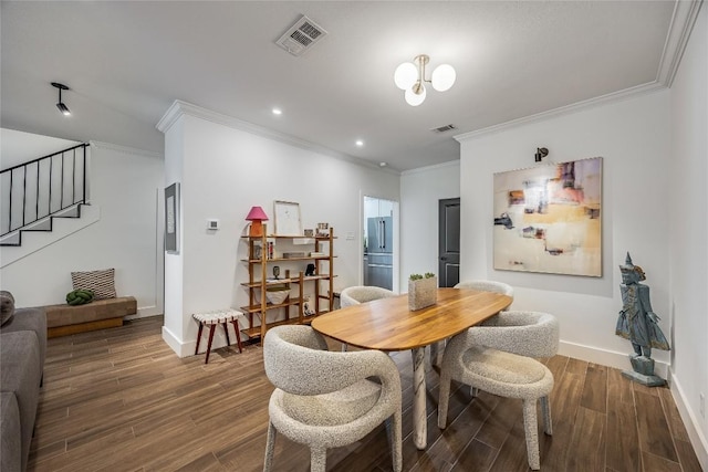 dining space with stairs, wood finished floors, visible vents, and baseboards