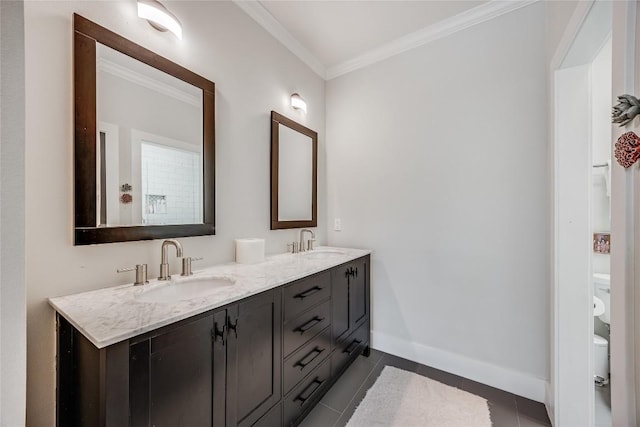 full bath with tile patterned flooring, crown molding, baseboards, and a sink