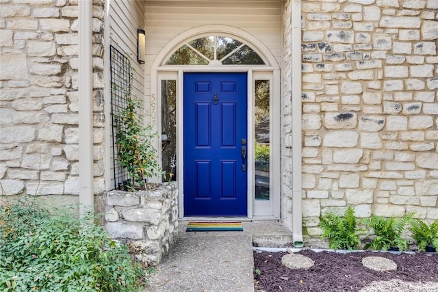 doorway to property featuring stone siding