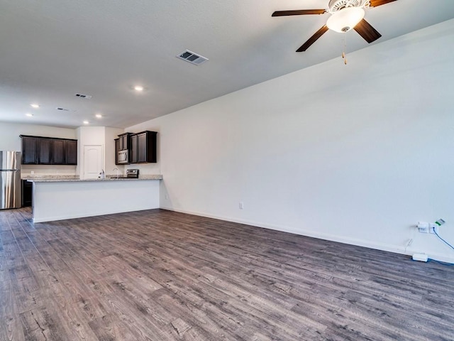 unfurnished living room featuring a ceiling fan, baseboards, visible vents, recessed lighting, and dark wood-type flooring