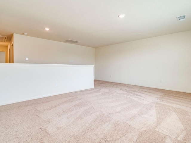 carpeted empty room with attic access, recessed lighting, and visible vents