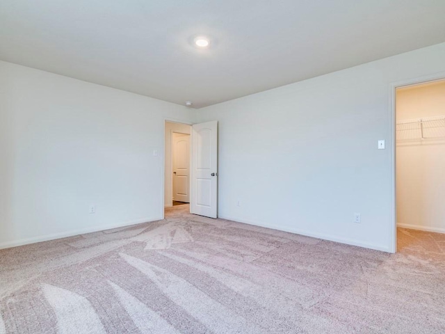 empty room featuring baseboards and carpet