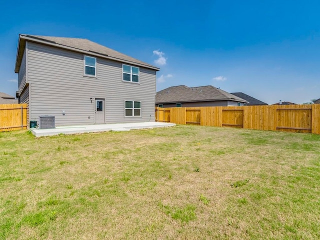 back of house with a lawn, central AC unit, a fenced backyard, and a patio area