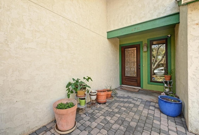 view of exterior entry featuring stucco siding