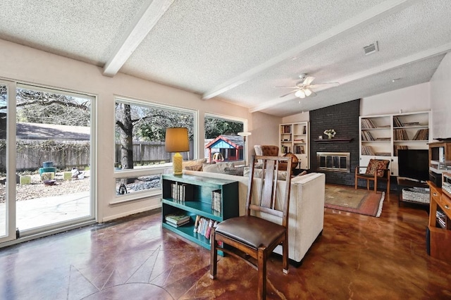 living room featuring visible vents, a textured ceiling, a fireplace, and vaulted ceiling with beams