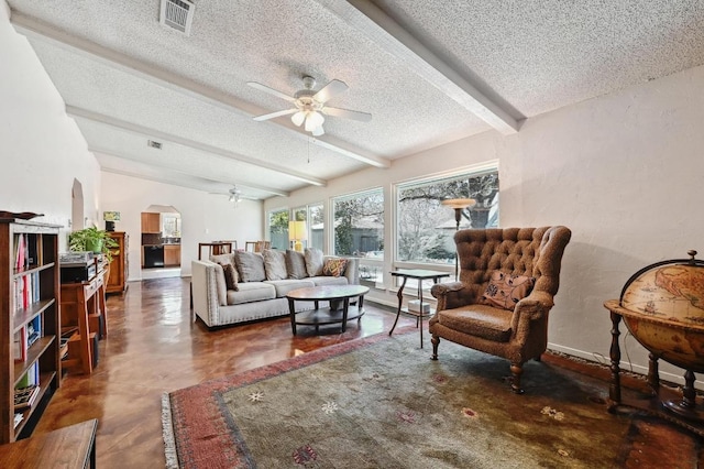 4711 Fieldstone Dr, Austin, TX 78735 - living room featuring a ceiling fan, a textured ceiling, beam ceiling, arched walkways, and finished concrete flooring