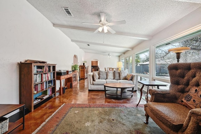 living room with visible vents, finished concrete flooring, beam ceiling, a textured ceiling, and a ceiling fan