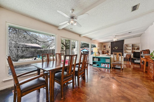 dining area featuring visible vents, vaulted ceiling with beams, ceiling fan, a textured ceiling, and a brick fireplace