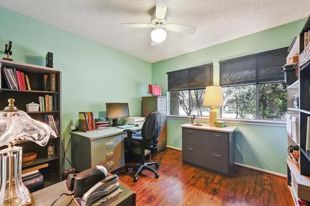 office space with baseboards, a textured ceiling, ceiling fan, and dark wood-style flooring