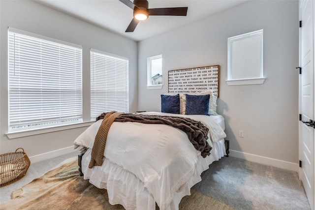 carpeted bedroom with a ceiling fan and baseboards