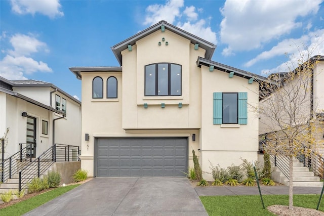 mediterranean / spanish-style house featuring stucco siding, concrete driveway, and a garage