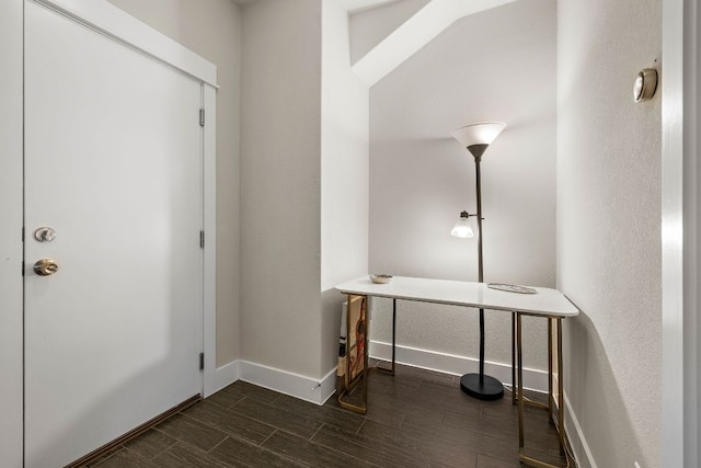 foyer with baseboards and wood tiled floor