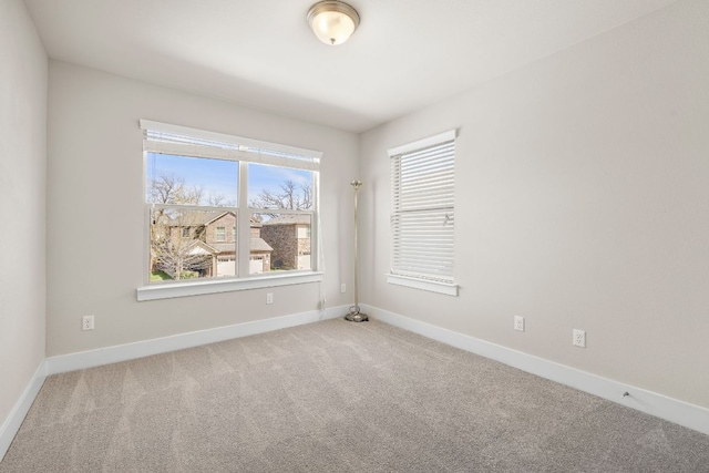 spare room with carpet flooring and baseboards