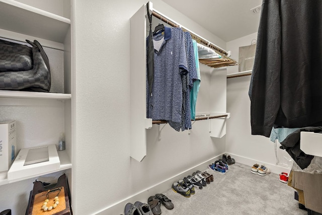 walk in closet featuring visible vents and carpet floors