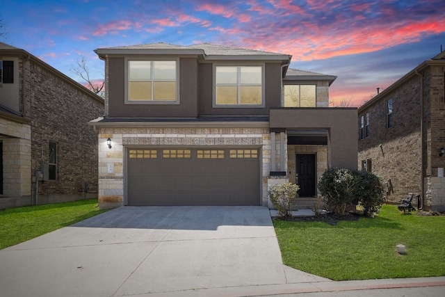 view of front of house featuring concrete driveway, a front yard, stucco siding, stone siding, and an attached garage