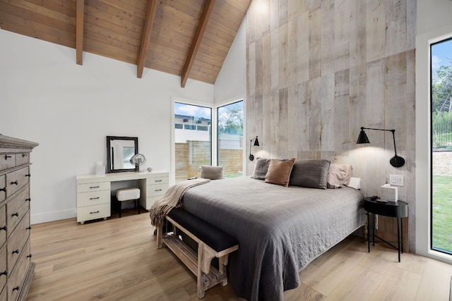 bedroom with beam ceiling, light wood-style flooring, wooden ceiling, and high vaulted ceiling