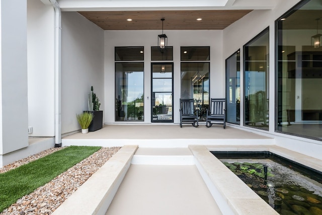 view of exterior entry with stucco siding