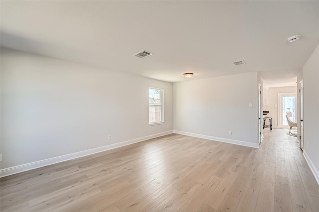 spare room with visible vents, baseboards, and light wood-style floors