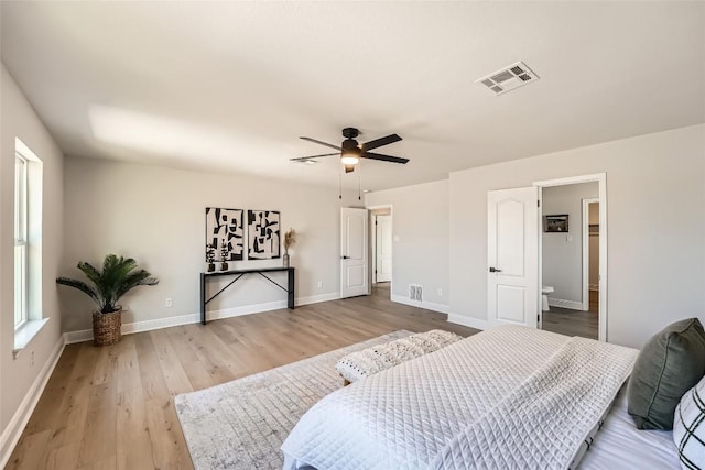 bedroom with light wood-type flooring, visible vents, baseboards, and ceiling fan