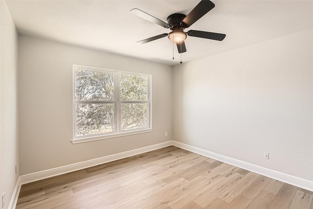 unfurnished room with a ceiling fan, baseboards, and light wood finished floors