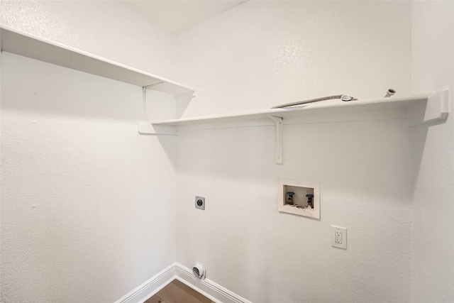 washroom featuring baseboards, dark wood finished floors, laundry area, electric dryer hookup, and washer hookup