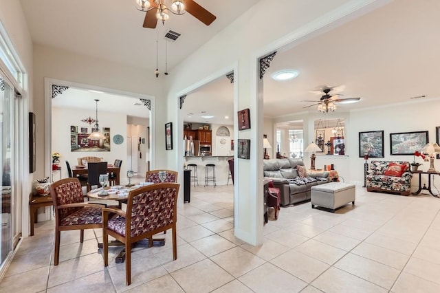 dining room featuring light tile patterned floors, visible vents, and ceiling fan