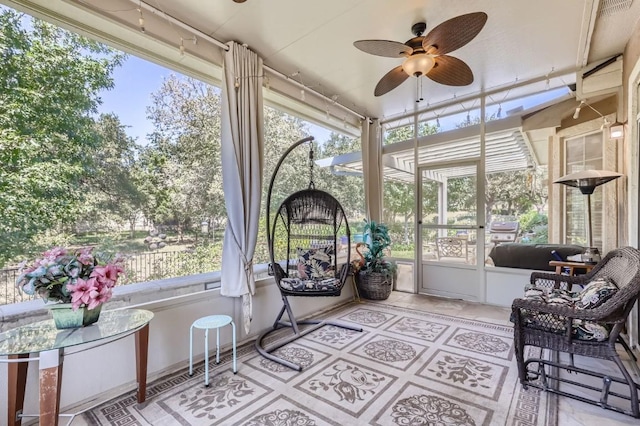 sunroom with a ceiling fan