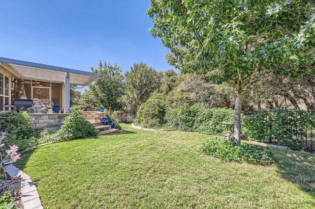 view of yard with ceiling fan