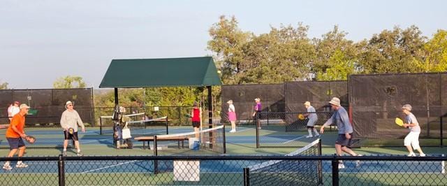 view of sport court featuring fence