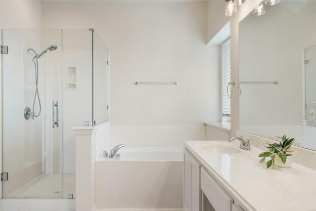 bathroom with a sink, a garden tub, double vanity, and a shower stall