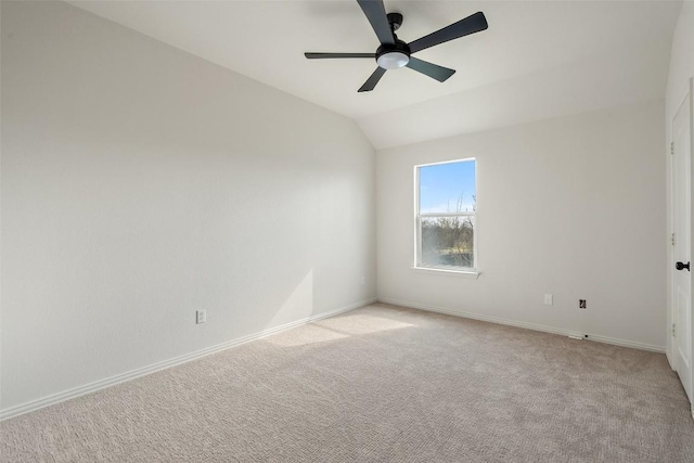 unfurnished room featuring baseboards, light carpet, a ceiling fan, and vaulted ceiling