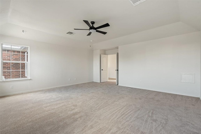 empty room with visible vents, baseboards, carpet, and a ceiling fan