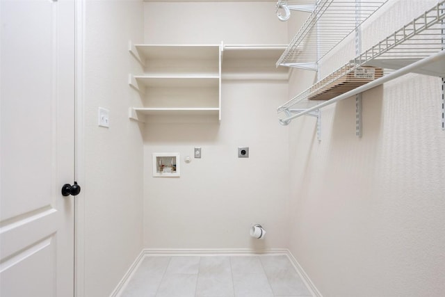 clothes washing area with electric dryer hookup, hookup for a gas dryer, baseboards, hookup for a washing machine, and laundry area