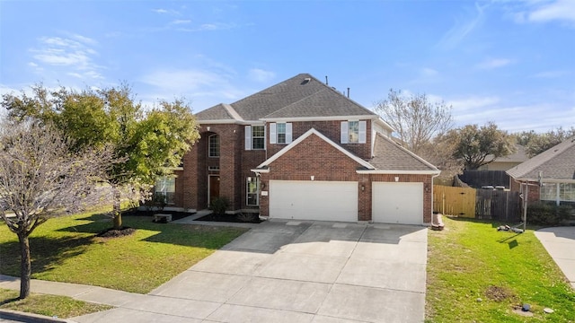 traditional-style house featuring brick siding, concrete driveway, fence, and a front yard