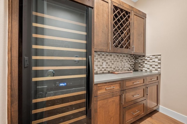 316 Duckhorn Pass, Austin, TX 78738 - indoor dry bar with beverage cooler, backsplash, and light wood-type flooring
