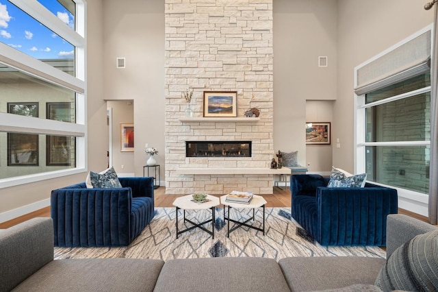 316 Duckhorn Pass, Austin, TX 78738 - living room with a towering ceiling, wood finished floors, and a fireplace