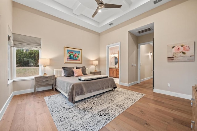 316 Duckhorn Pass, Austin, TX 78738 - bedroom with light wood-type flooring, coffered ceiling, beam ceiling, connected bathroom, and a ceiling fan