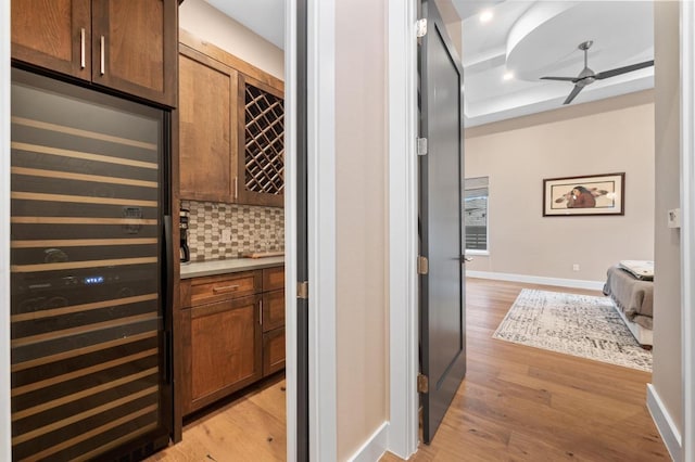 316 Duckhorn Pass, Austin, TX 78738 - wine room featuring beverage cooler, light wood-type flooring, and ceiling fan