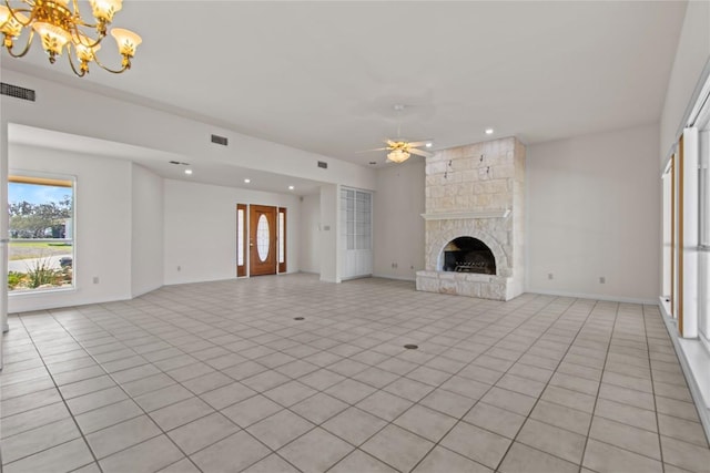 25048 River Rd, Spicewood, TX 78669 - unfurnished living room featuring a chandelier, ceiling fan, light tile patterned floors, recessed lighting, and a fireplace