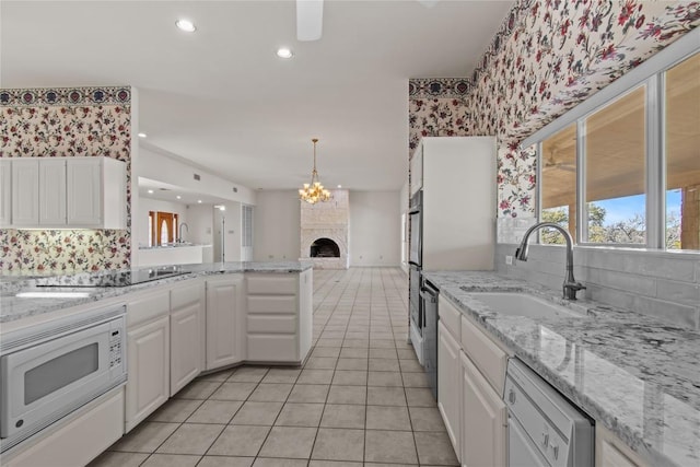 25048 River Rd, Spicewood, TX 78669 - kitchen with white appliances, tasteful backsplash, white cabinets, light tile patterned flooring, and wallpapered walls