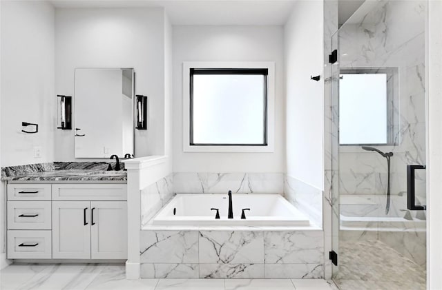 bathroom featuring vanity, a garden tub, marble finish floor, and a marble finish shower