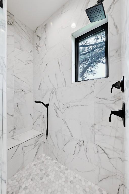 full bath featuring a marble finish shower