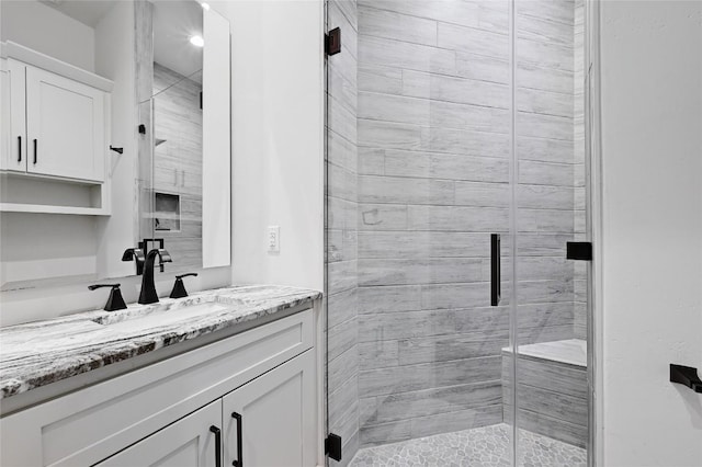 full bathroom with vanity and a shower stall